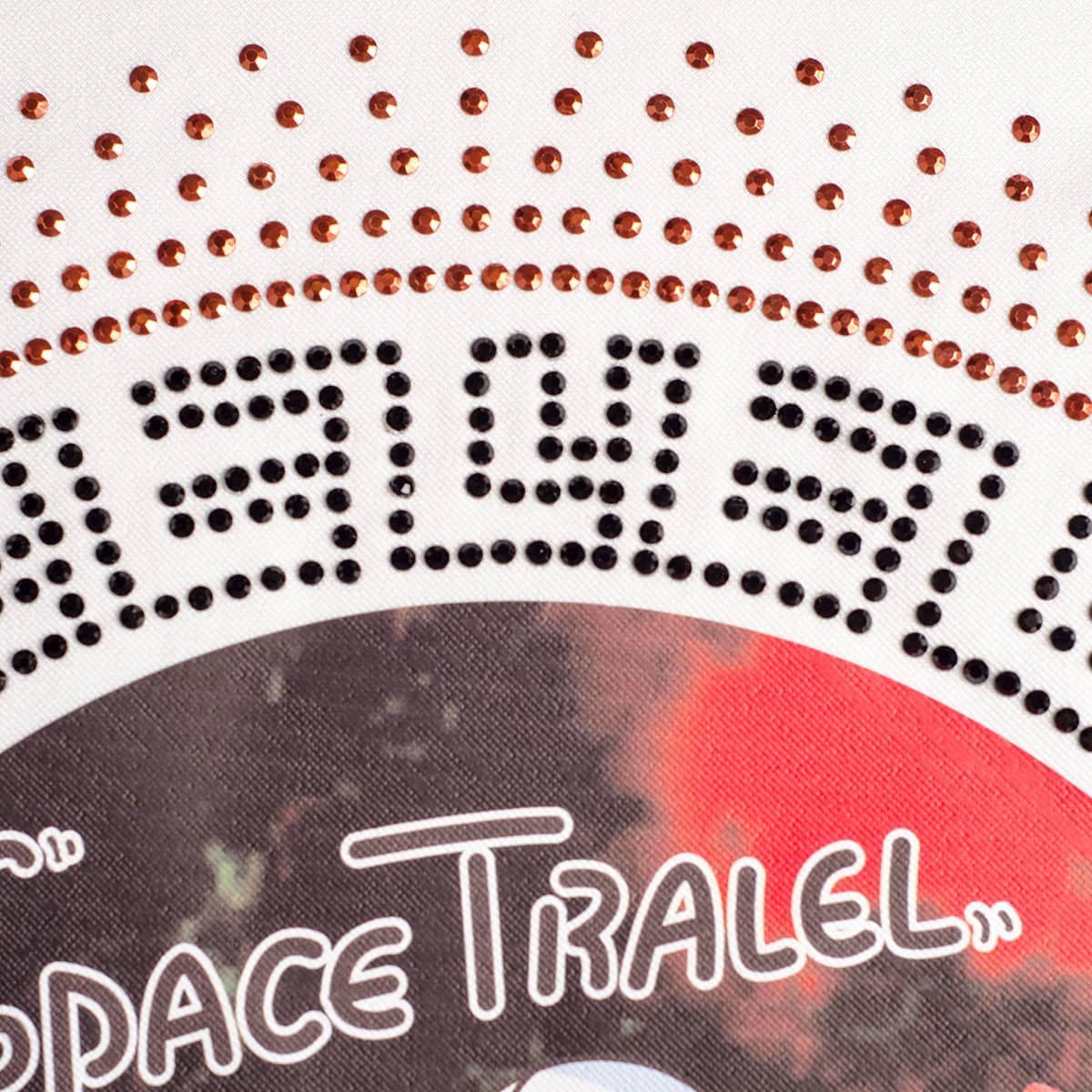 hotfix rhinestone transfer and printed hotfix transfer, combined with a simulated Austrian rhinestone and a printed spaceman pattern, with adhesive rhinestone transfers