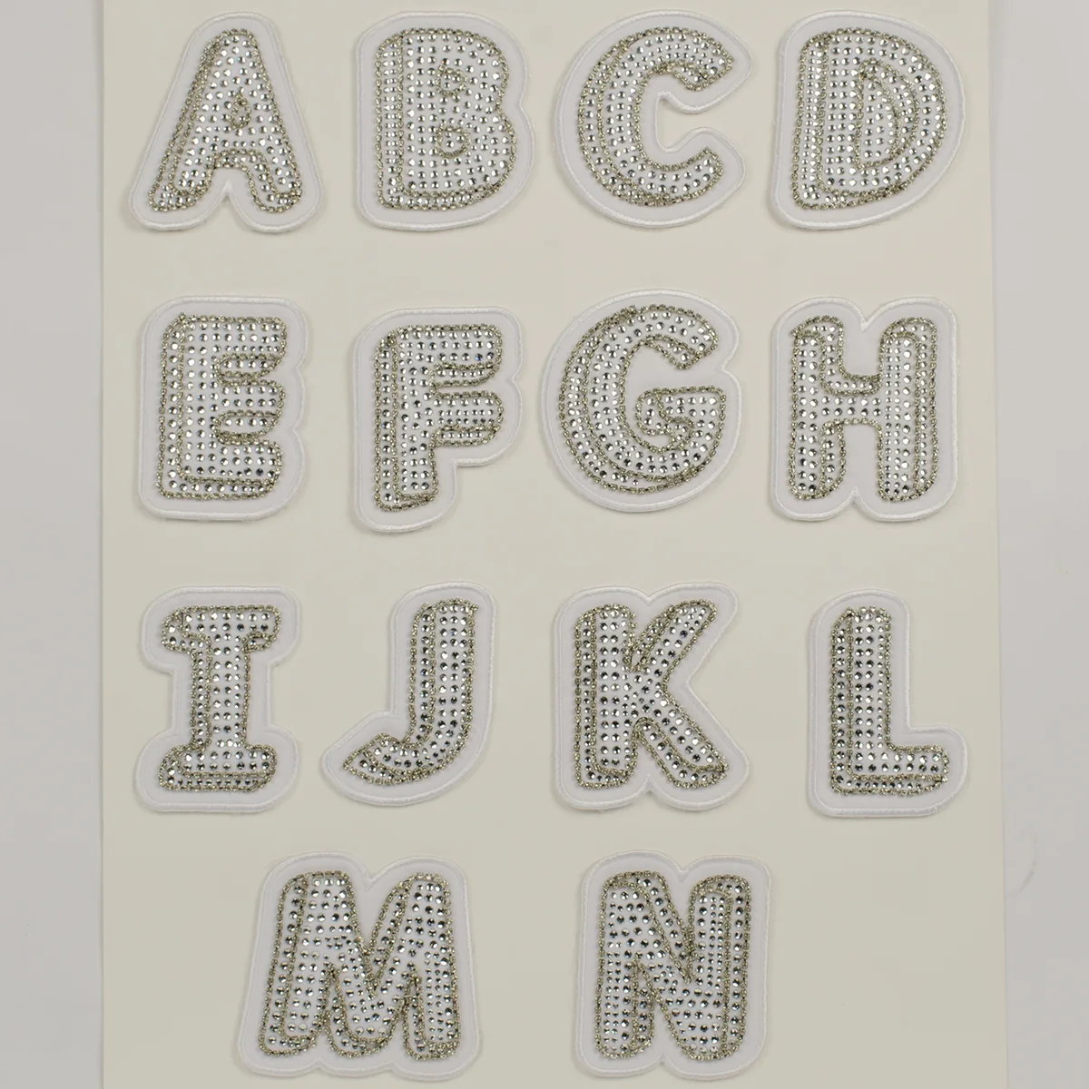 White embroidered sew-on uppercase patches filled with clear crystals