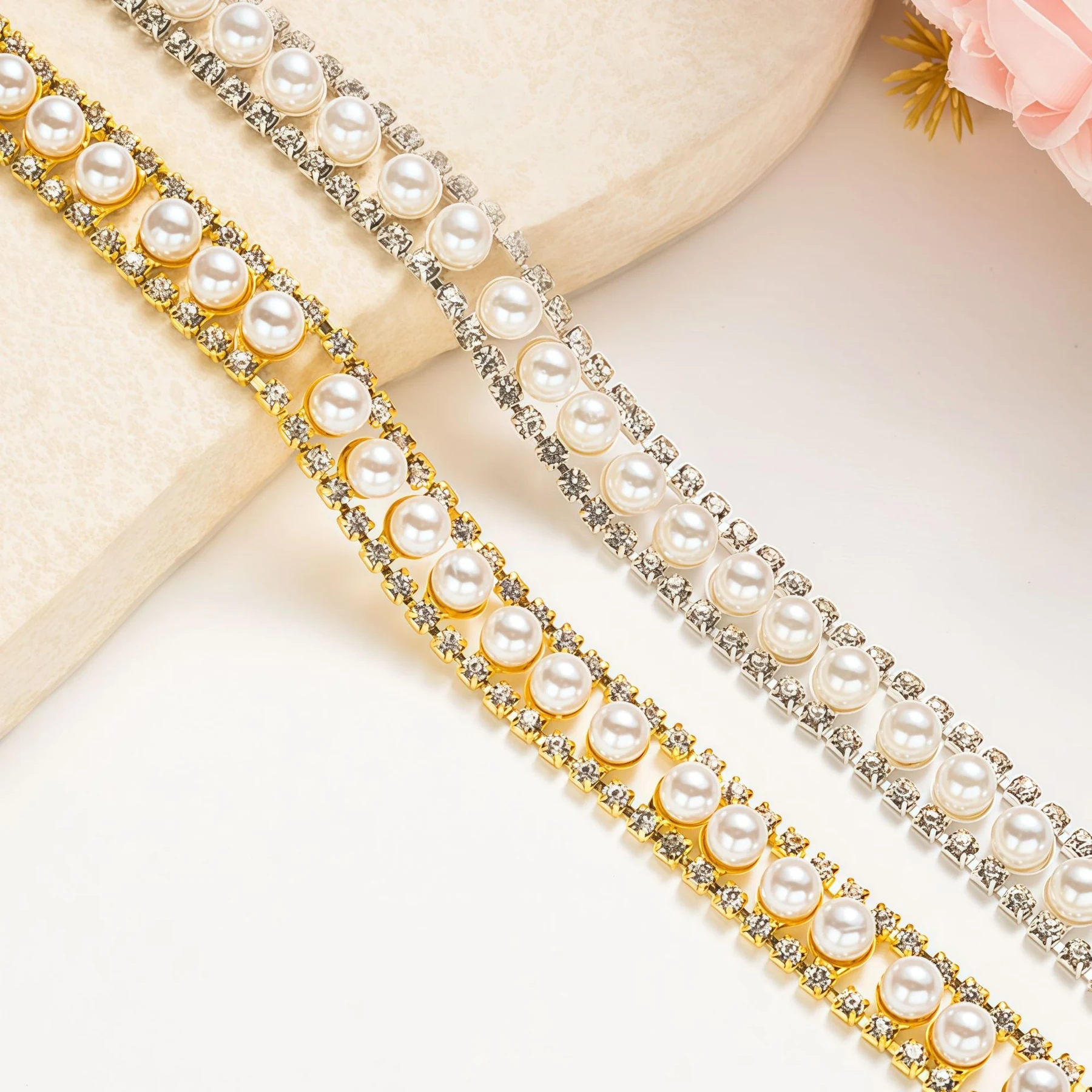 Pearl-look center row framed by rhinestones in silver and gold tone chain trims