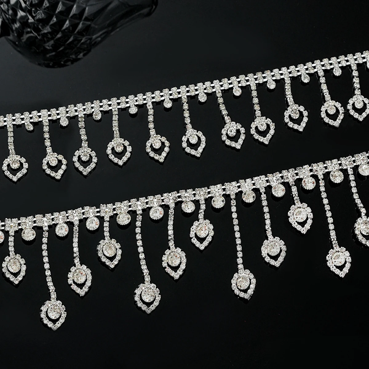 Silver-white rhinestone fringe with even and irregular heart-shaped drops