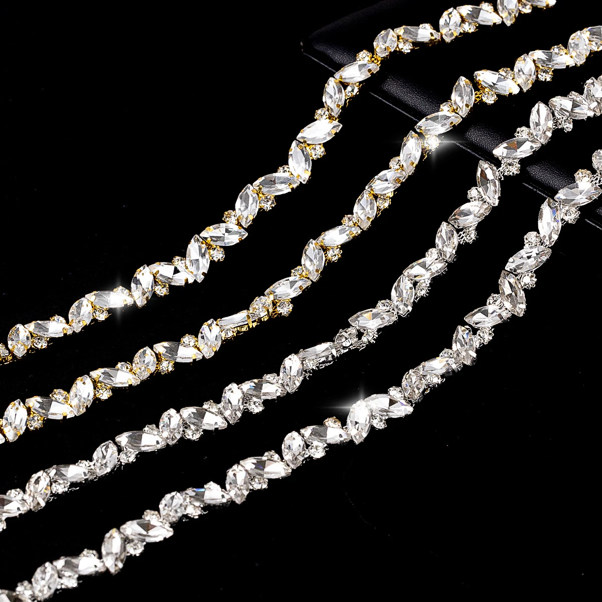 Crossed marquise rhinestone chains in silver-white and gold-white finishes