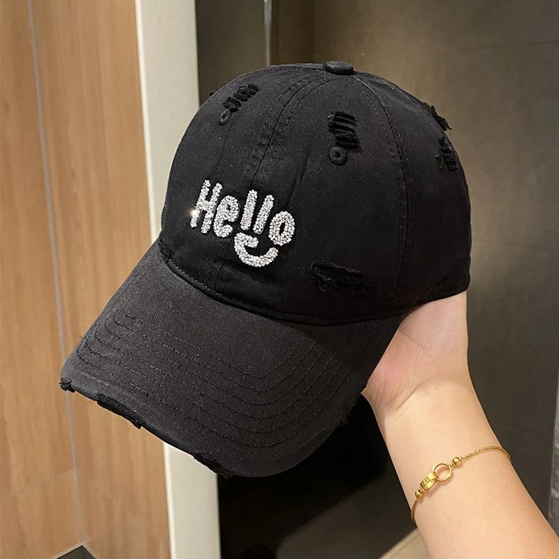 Distressed cotton baseball cap with rhinestone Hello lettering in seven colors